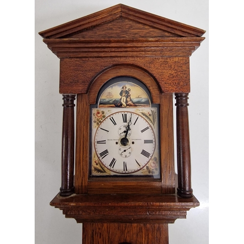 687 - A miniature battery-operated longcase clock, together with a brass port-hole clock. A/F condition.
R... 