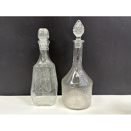 220 - Four vintage decanters & two water jugs.