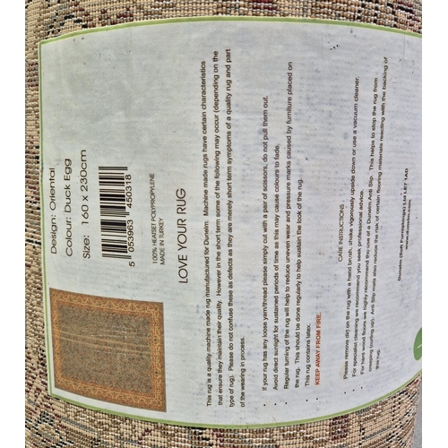 389 - Manmade Turkish rug, in duck egg blue oriental style, by Dunelm. Dimensions 230cm x 160cm.