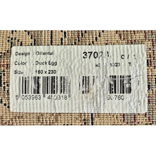 389 - Manmade Turkish rug, in duck egg blue oriental style, by Dunelm. Dimensions 230cm x 160cm.