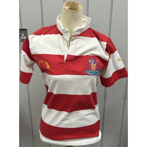 865 - Six Gloucester RFC shirts, together with a pair of Bristol City FC shin pads.