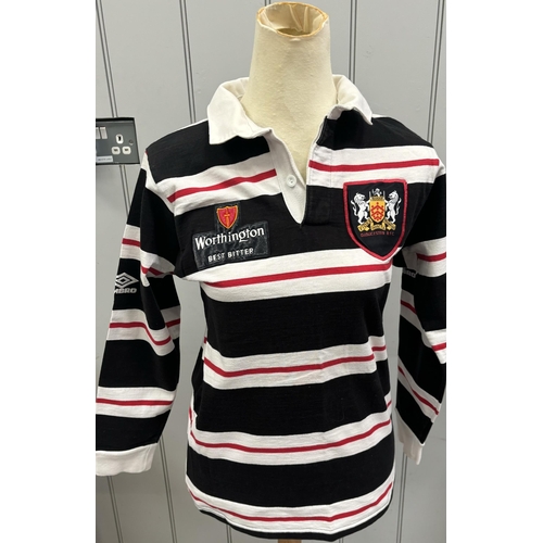 865 - Six Gloucester RFC shirts, together with a pair of Bristol City FC shin pads.