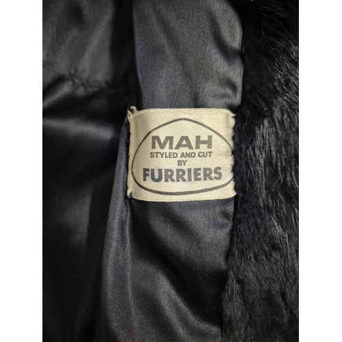 1166 - A vintage MAH black fur coat, together with an 'Astraka' faux fur white fur example (size 12).