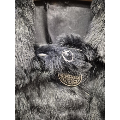 1166 - A vintage MAH black fur coat, together with an 'Astraka' faux fur white fur example (size 12).