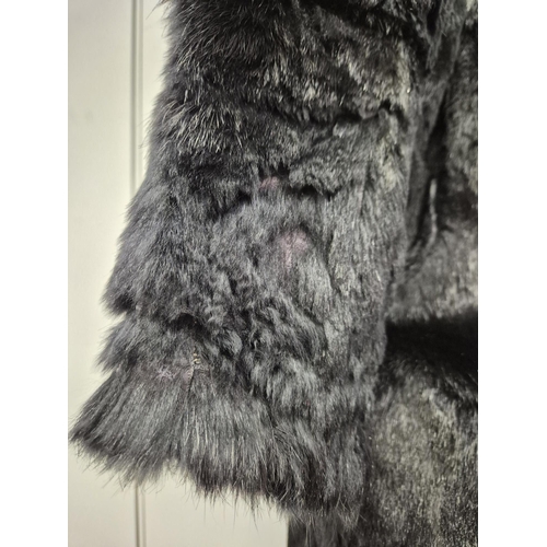 1166 - A vintage MAH black fur coat, together with an 'Astraka' faux fur white fur example (size 12).