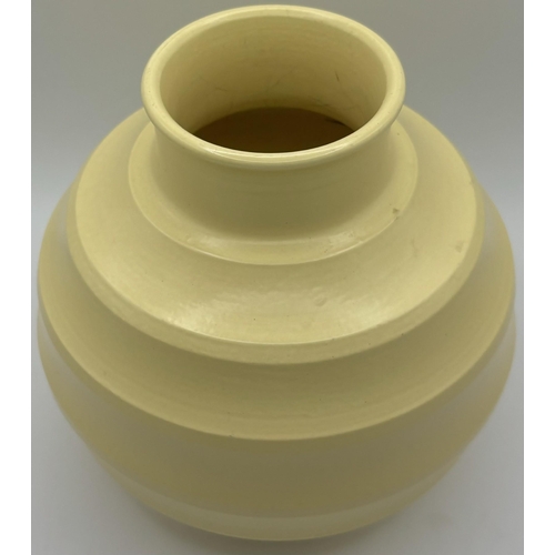 Keith Murray for Wedgwood ribbed 'football' vase, in matt straw glaze, printed marks to base, c.1930. Height 16cm, diameter 15cm.