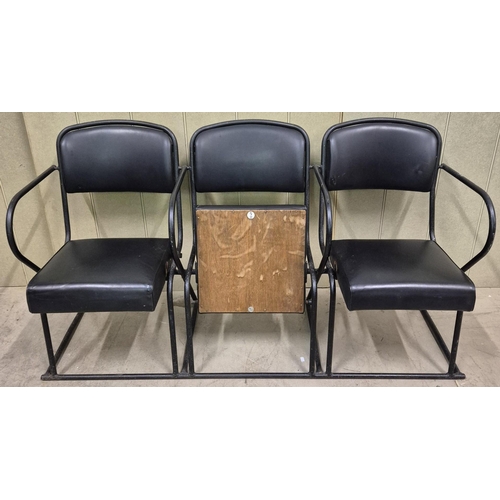 7025 - A bank of three original folding cinema seats, by 'PEL'. Tubular steel framed, with black leather se... 