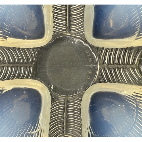 41 - Lalique Coquilles plate. Made of opalescent glass, the design features a geometric pattern on raised... 