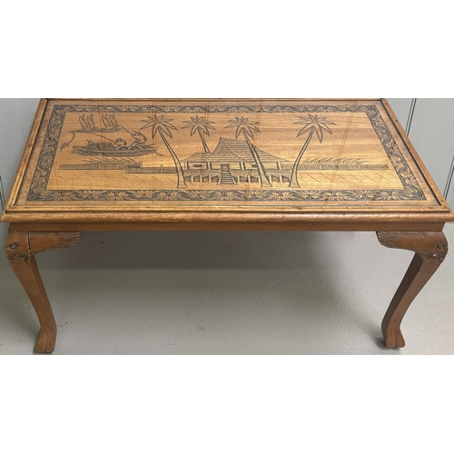 256 - Carved coffee table depicting an oriental scene. Complete with glass protector. Dimensions(cm) H47, ... 