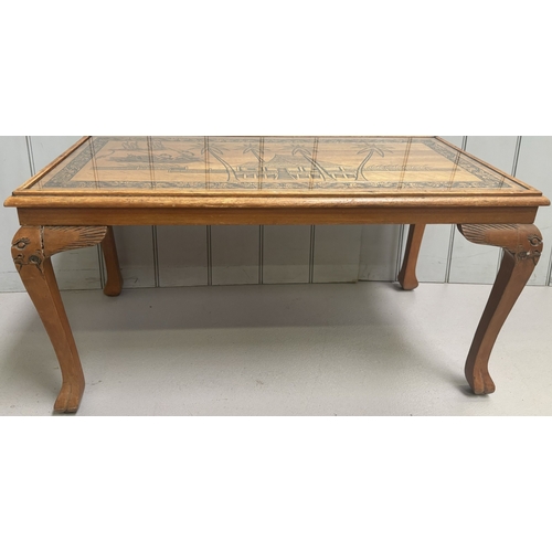 256 - Carved coffee table depicting an oriental scene. Complete with glass protector. Dimensions(cm) H47, ... 