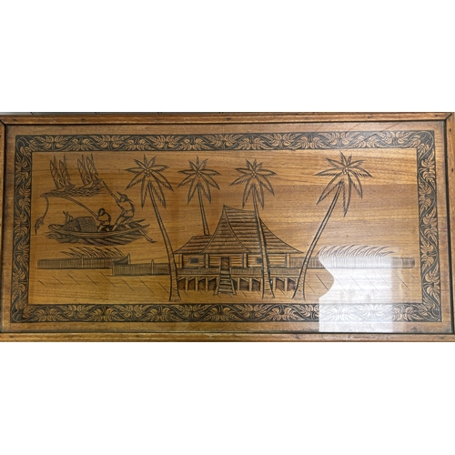 256 - Carved coffee table depicting an oriental scene. Complete with glass protector. Dimensions(cm) H47, ... 