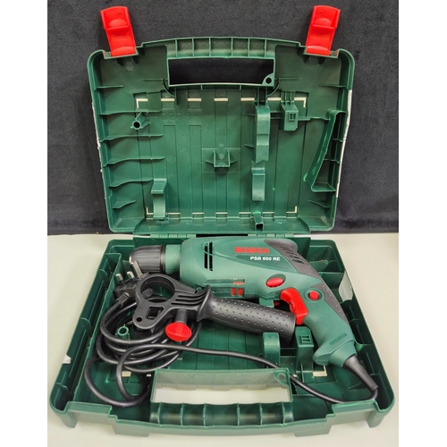 283 - Bosch PSB650E hammer drill, with case. Appears hardly used. PAT test pass & functionality test indic... 