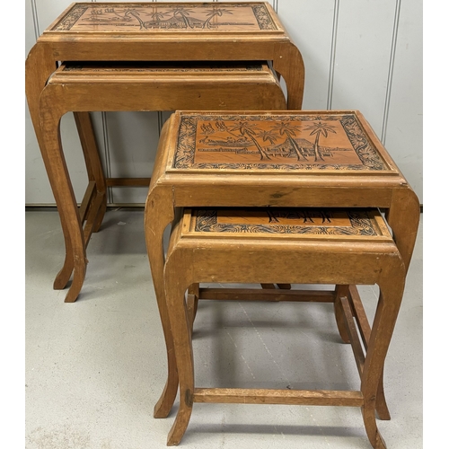 294 - Carved nest of 4 tables depicting an oriental scene. Complete with glass protectors. Largest dimensi... 