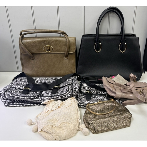 Collection of 7 handbags. Most appear unused.