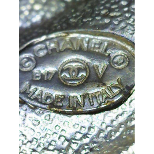 1703 - Chanel white metal/crystal-set brooch in the form of  interlocking C's logo. Complete with original ... 