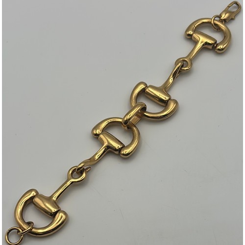 1749 - 22ct gold (acid tests as) heavy horse-bit bracelet, in the style of Gucci. Features large carabiner ... 