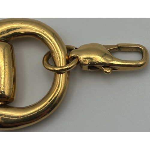 1749 - 22ct gold (acid tests as) heavy horse-bit bracelet, in the style of Gucci. Features large carabiner ... 