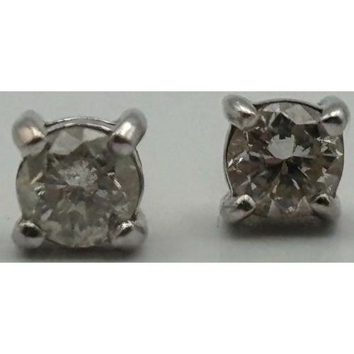 1752 - 18ct gold, hallmarked, single stone diamond earrings. Set in classic white gold, four-claw settings ... 
