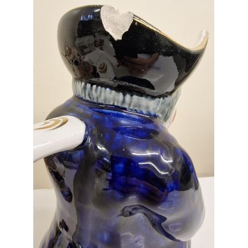 2101 - A mixed lot of ceramics. To include a large scale Toby jug, two steins (one musical), mug & jar.