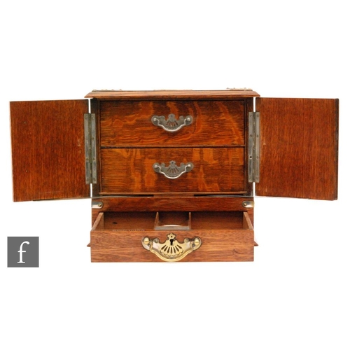 275 - A late 19th to early 20th Century oak smokers cabinet with plated mounts and with twin carry handles... 