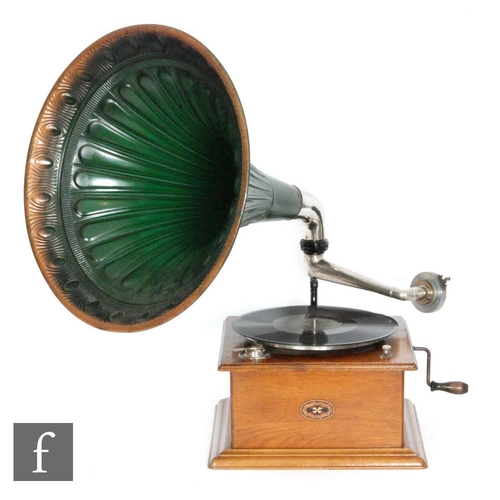 312 - A 1920s Continental oak cased wind up gramophone with green tin horn on stepped plinth base, width 3... 