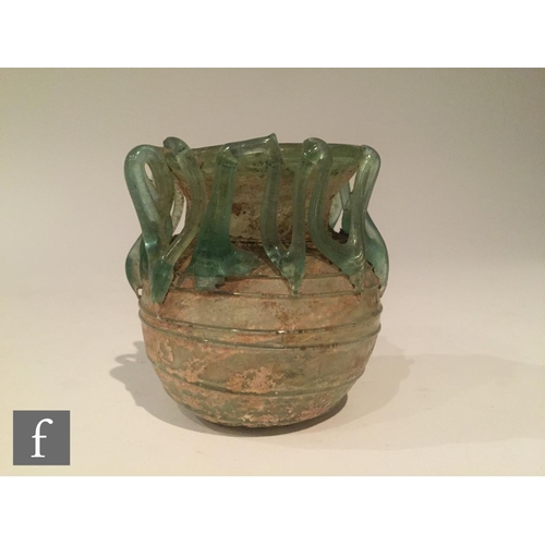 119 - Roman 2nd to 4th Century AD - A pale blue glass bowl with ribbed body and applied lattice decoration... 