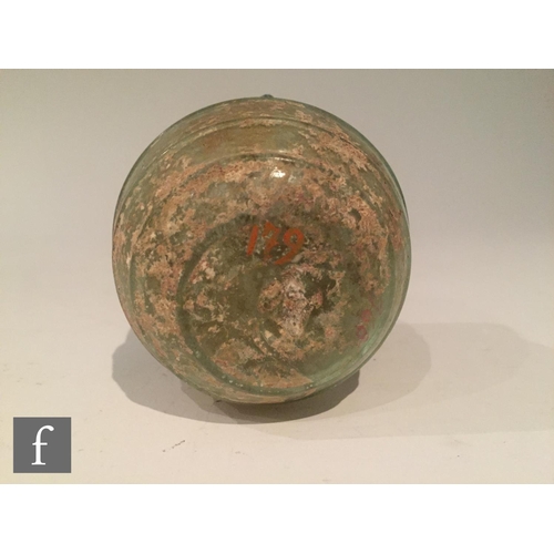 119 - Roman 2nd to 4th Century AD - A pale blue glass bowl with ribbed body and applied lattice decoration... 