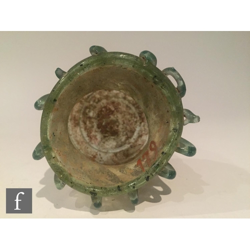 119 - Roman 2nd to 4th Century AD - A pale blue glass bowl with ribbed body and applied lattice decoration... 