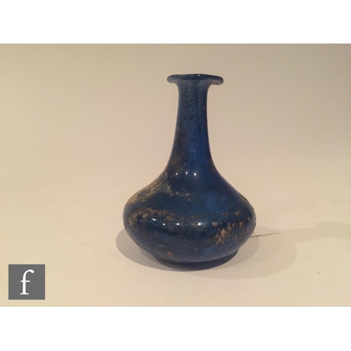 126 - Roman 2nd to 4th Century AD - A miniature blue glass flask, the slender neck to an ovoid base, heigh... 