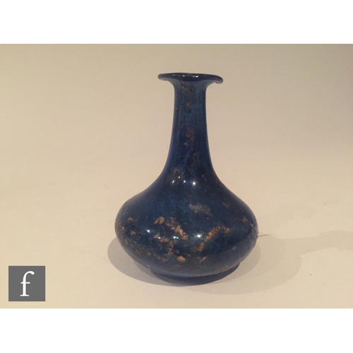 126 - Roman 2nd to 4th Century AD - A miniature blue glass flask, the slender neck to an ovoid base, heigh... 