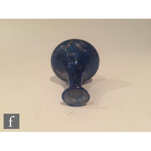 126 - Roman 2nd to 4th Century AD - A miniature blue glass flask, the slender neck to an ovoid base, heigh... 