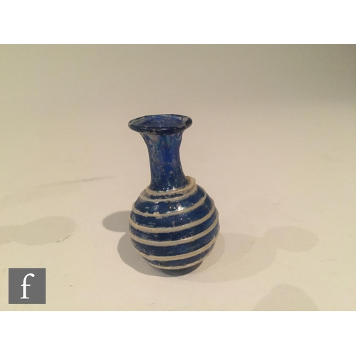 127 - Roman 2nd to 4th Century AD - A miniature cobalt blue globular form flask decorated with white bee h... 