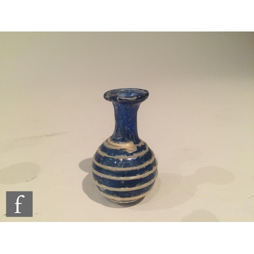 127 - Roman 2nd to 4th Century AD - A miniature cobalt blue globular form flask decorated with white bee h... 