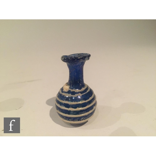 127 - Roman 2nd to 4th Century AD - A miniature cobalt blue globular form flask decorated with white bee h... 