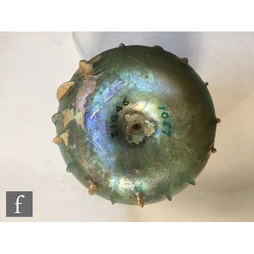 118 - Roman 2nd to 3rd Century AD - An iridescent green glass beaker with flared rim and slashed ribs to t... 