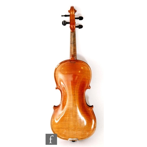 58 - A 1920 to 1930's violin, the reverse stamped Stainer, length of back 35.5cm and with a bow, cased.