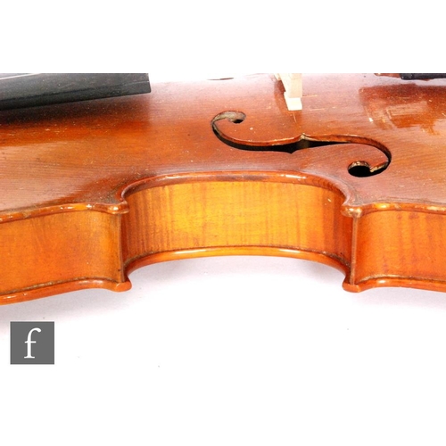 58 - A 1920 to 1930's violin, the reverse stamped Stainer, length of back 35.5cm and with a bow, cased.