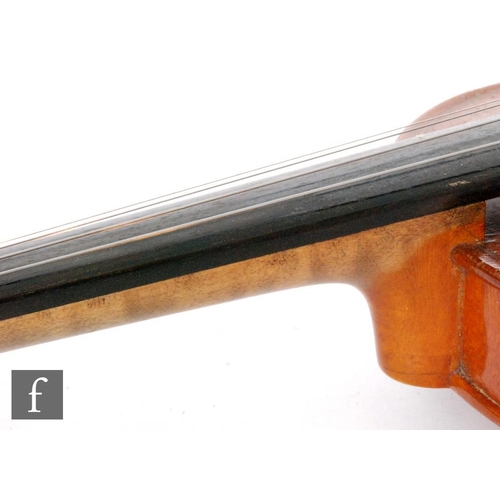 58 - A 1920 to 1930's violin, the reverse stamped Stainer, length of back 35.5cm and with a bow, cased.