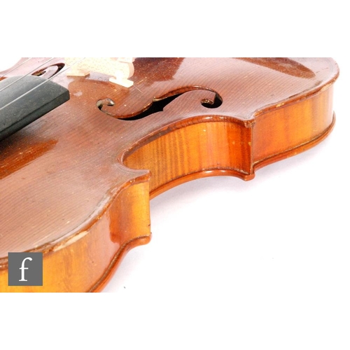 58 - A 1920 to 1930's violin, the reverse stamped Stainer, length of back 35.5cm and with a bow, cased.