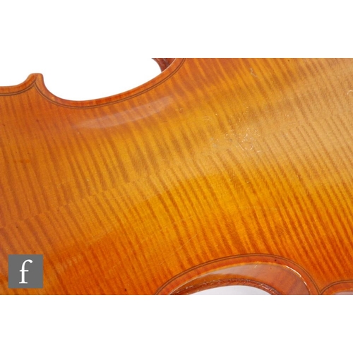 58 - A 1920 to 1930's violin, the reverse stamped Stainer, length of back 35.5cm and with a bow, cased.