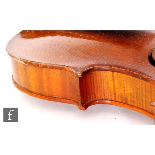 58 - A 1920 to 1930's violin, the reverse stamped Stainer, length of back 35.5cm and with a bow, cased.