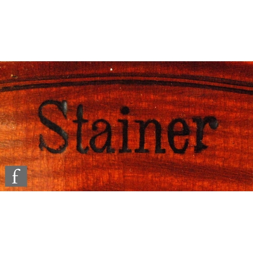 58 - A 1920 to 1930's violin, the reverse stamped Stainer, length of back 35.5cm and with a bow, cased.