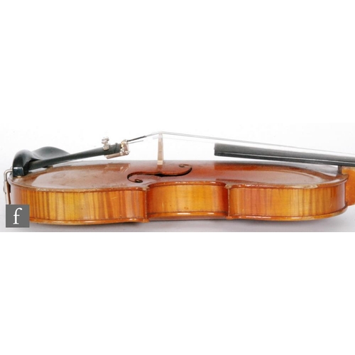 58 - A 1920 to 1930's violin, the reverse stamped Stainer, length of back 35.5cm and with a bow, cased.