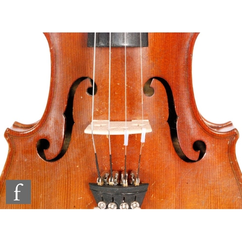 58 - A 1920 to 1930's violin, the reverse stamped Stainer, length of back 35.5cm and with a bow, cased.