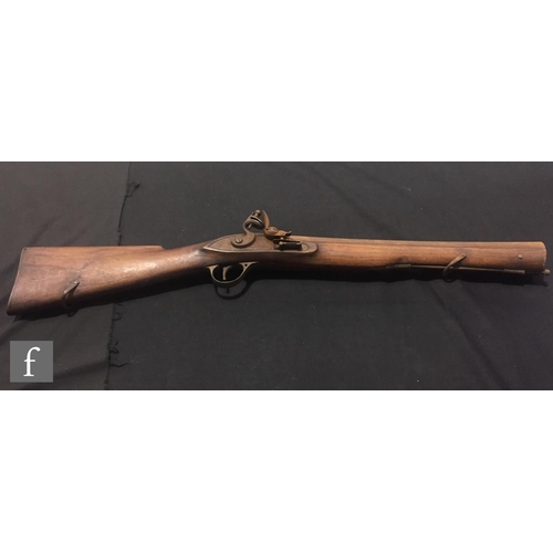 340 - An Indian flintlock blunderbuss with ramrod and brass trigger guard, length 45cm and a single barrel... 