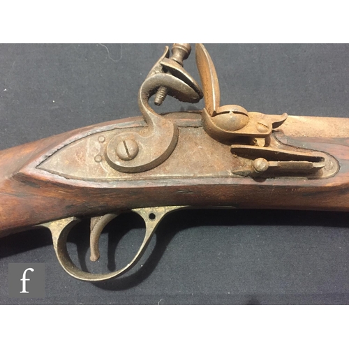 340 - An Indian flintlock blunderbuss with ramrod and brass trigger guard, length 45cm and a single barrel... 