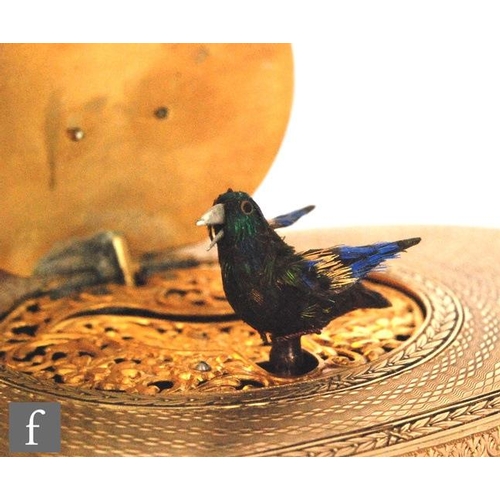 355 - A 19th Century continental silver gilt singing bird box, the engine turned oval box with a watch to ... 