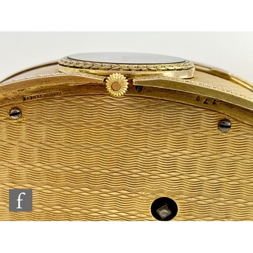 355 - A 19th Century continental silver gilt singing bird box, the engine turned oval box with a watch to ... 