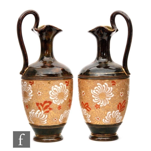 110 - A pair of Doulton Slaters Patent Chine Ware ewers of footed ovoid form with floral decoration within... 