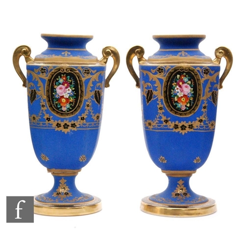 111 - A pair of Noritake pedestal vases each decorated with sprays of flowers against a matt blue ground w... 
